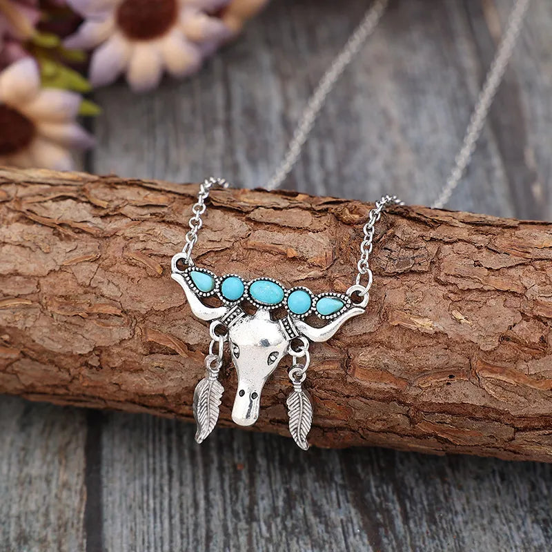 Silver necklace with turquoise bull head and feather charms