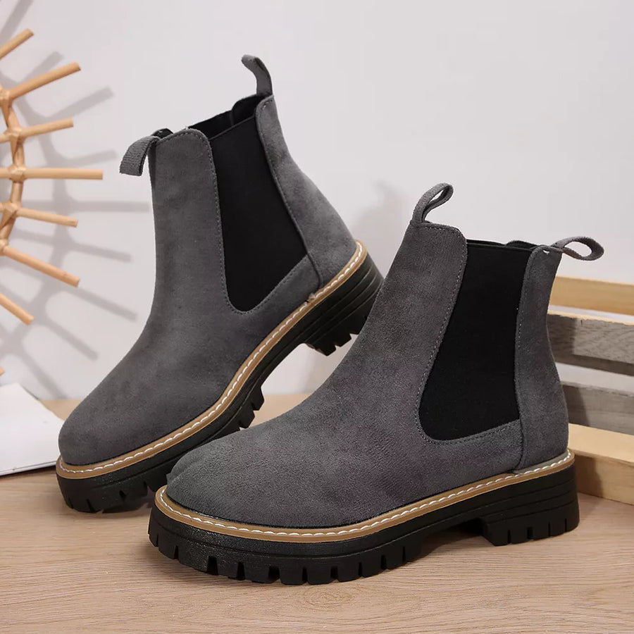 Gray suede chelsea ankle boots with chunky sole and elastic side panels.