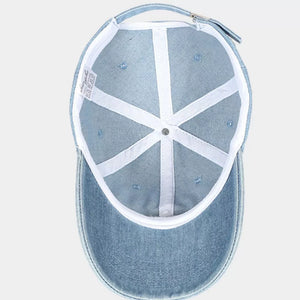 Light wash denim baseball cap with white interior lining and adjustable strap