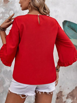 Red ruffled sleeve blouse with button detail and keyhole neckline.