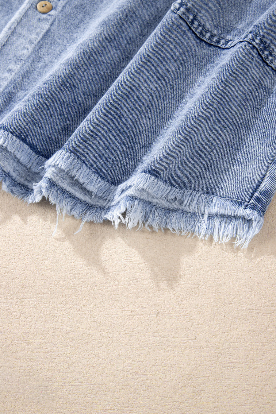 Acid wash denim shirtdress in medium with raw hem detail and button closure.