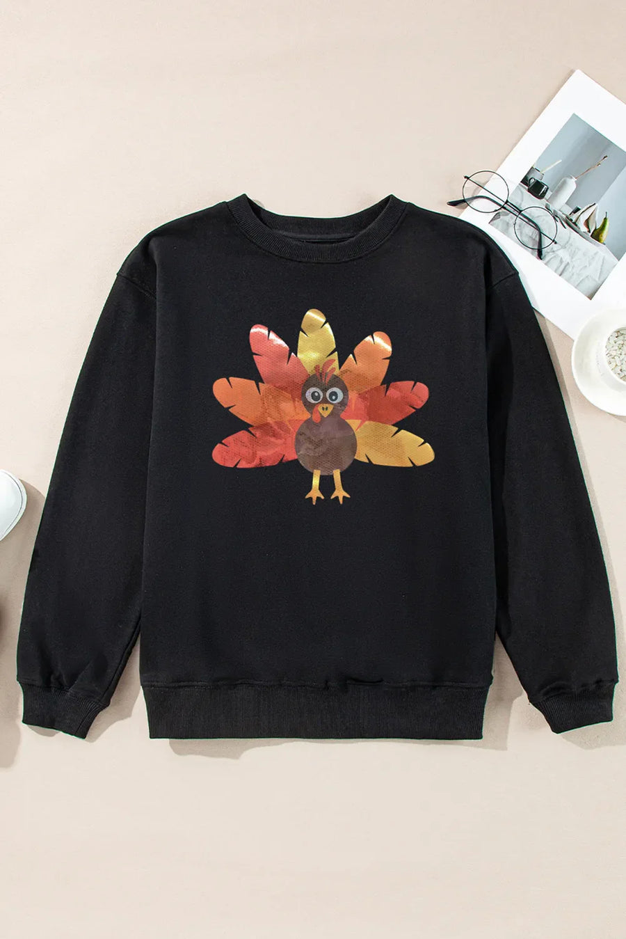 Black crewneck sweatshirt with a cartoon turkey graphic on the front.