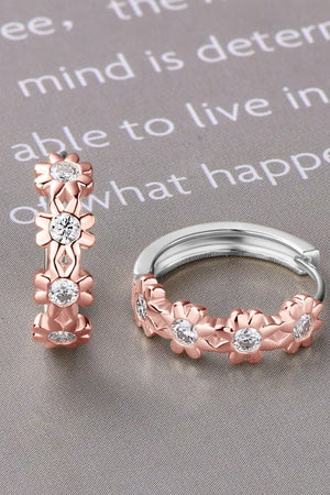 Rose gold huggie hoop earrings with floral embellishments and clear stones
