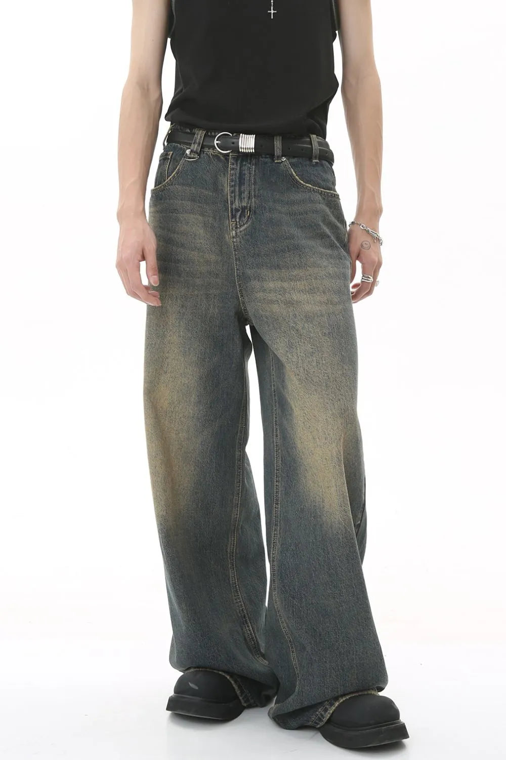 Faded wash palazzo denim trousers in a medium blue with a wide leg and distressed details.