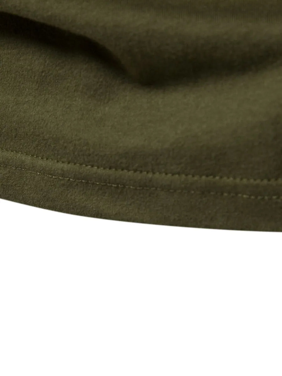 Army green raglan tee detail showing double-stitched hem and soft fabric texture.
