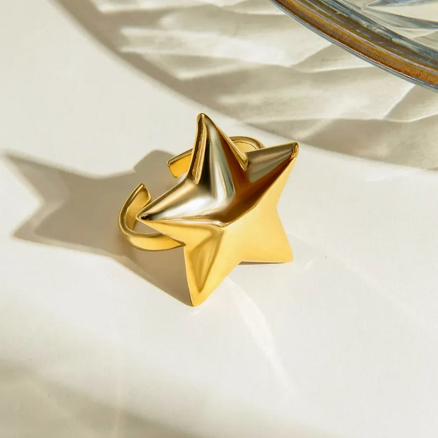 Gold starburst adjustable ring with bold sculptural detail.