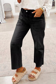 Black high-waisted cropped jeans with raw hem and utility pockets.