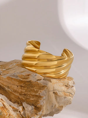 Sculpted Wave Cuff Bracelet in gold, featuring a textured, wavy design.