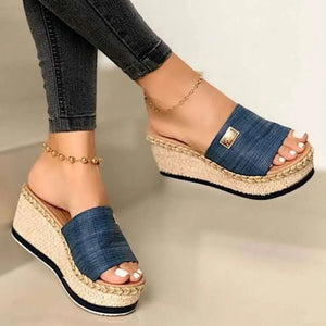 Textured platform slides in dark blue denim with metallic detail and espadrille wedge.