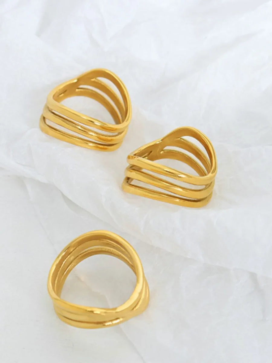 Triple-band sculptural ring in gold, 18K gold-plated, with wavy bands.