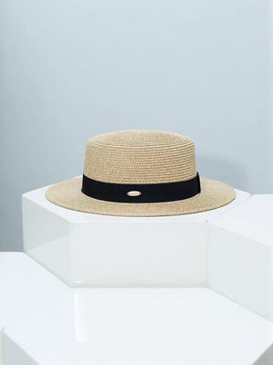 Timeless straw boater hat with elegant black band and gold accent.
