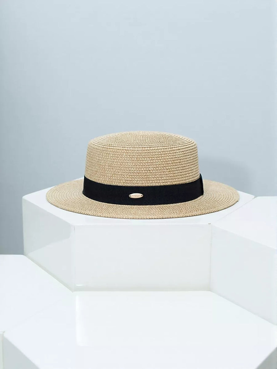 Timeless straw boater hat with elegant black band and gold accent.