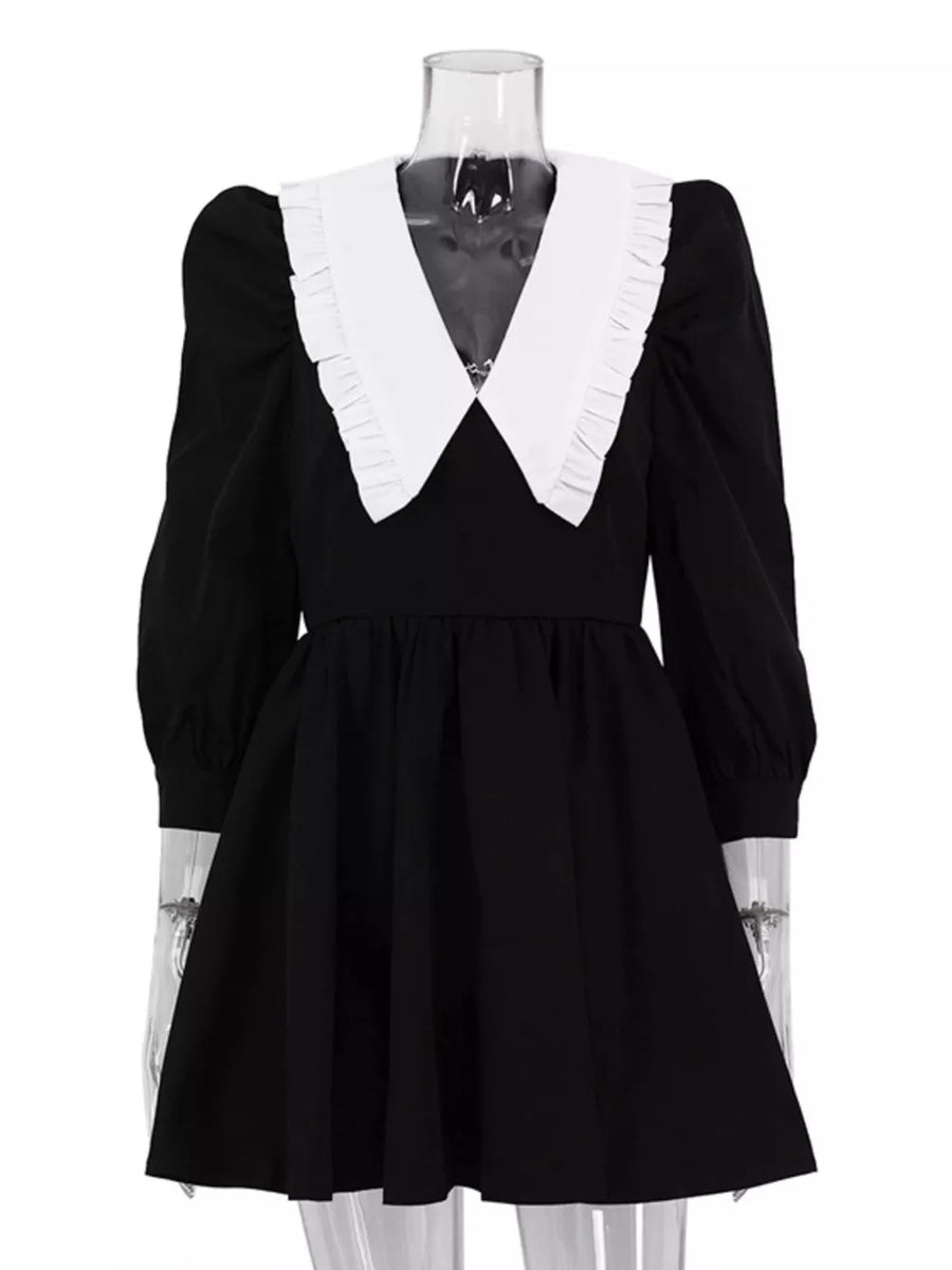 Black dress with white ruffled collar and puff sleeves