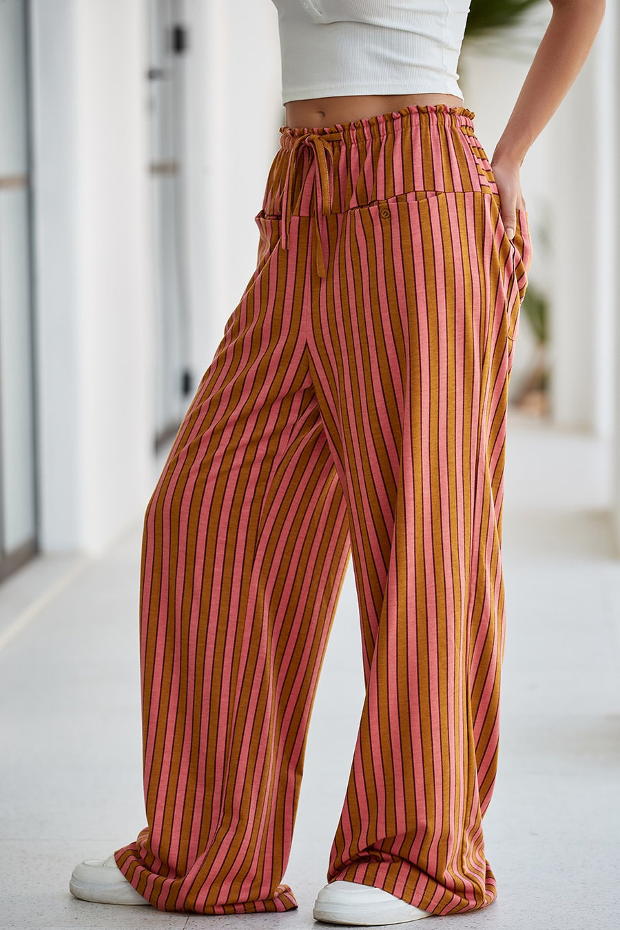 Wide leg pants with pink and brown vertical stripes, drawstring waist, and pockets.