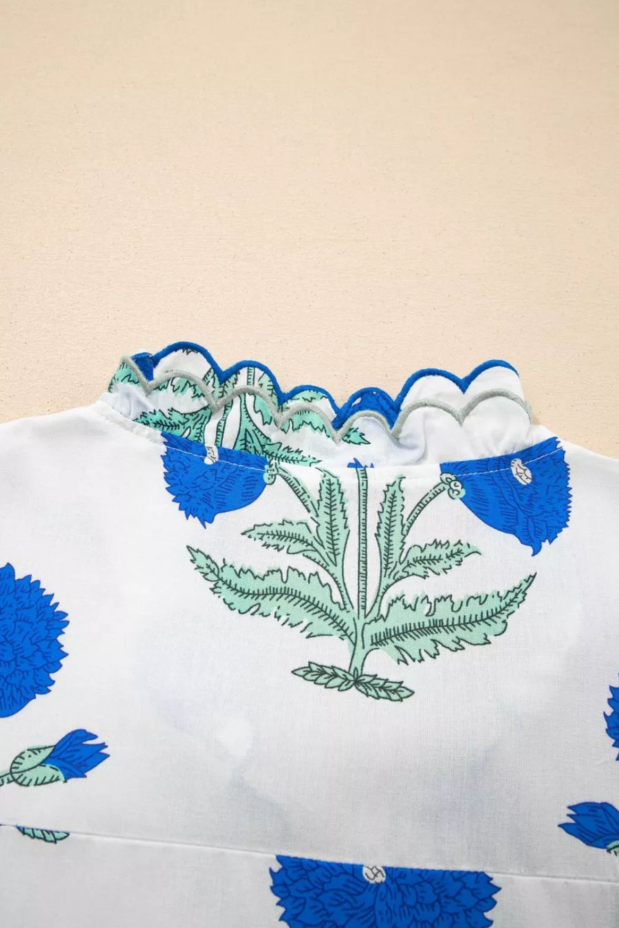 White cotton blouse with blue floral print and scalloped trim neckline