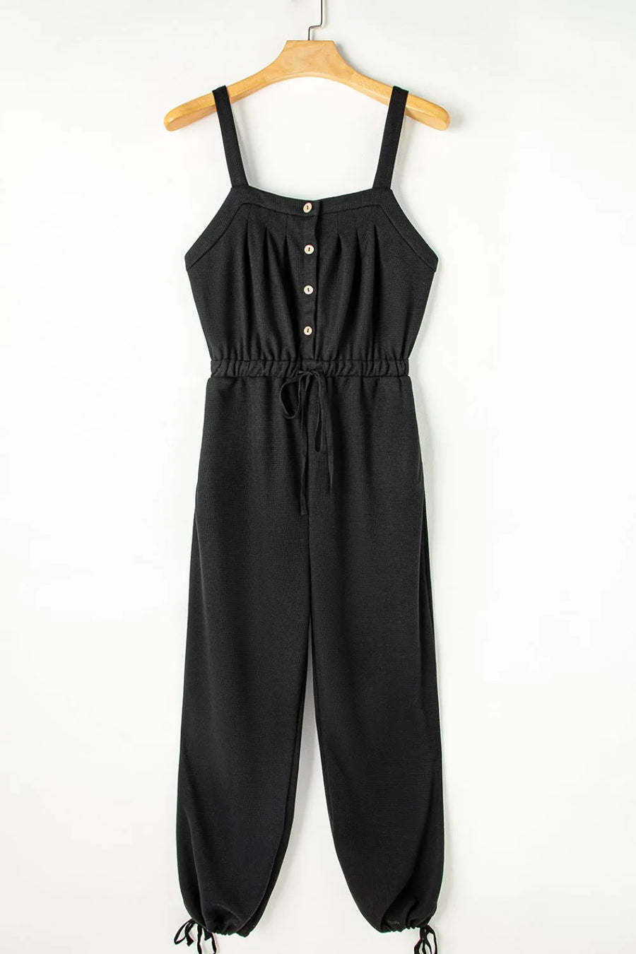 Black waffle knit wide leg jumpsuit with button front and drawstring waist
