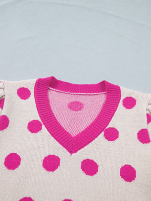 Cream knit top with hot pink polka dots and V-neck with pink trim. Puff sleeves visible.