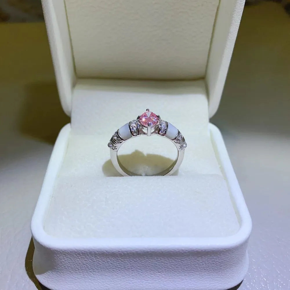 Silver ring with pink oval moissanite and mother-of-pearl accents