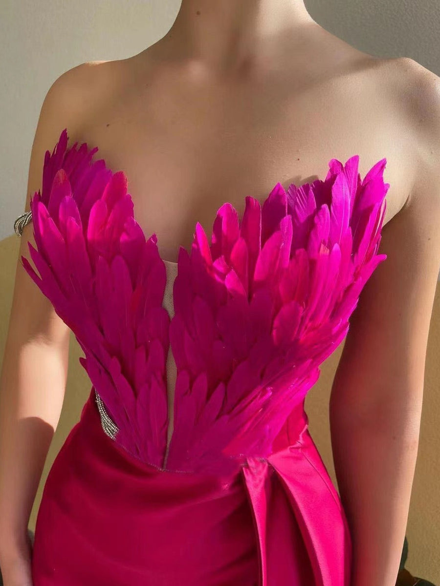 Rose Red feather embellished strapless maxi dress with draped skirt detail.