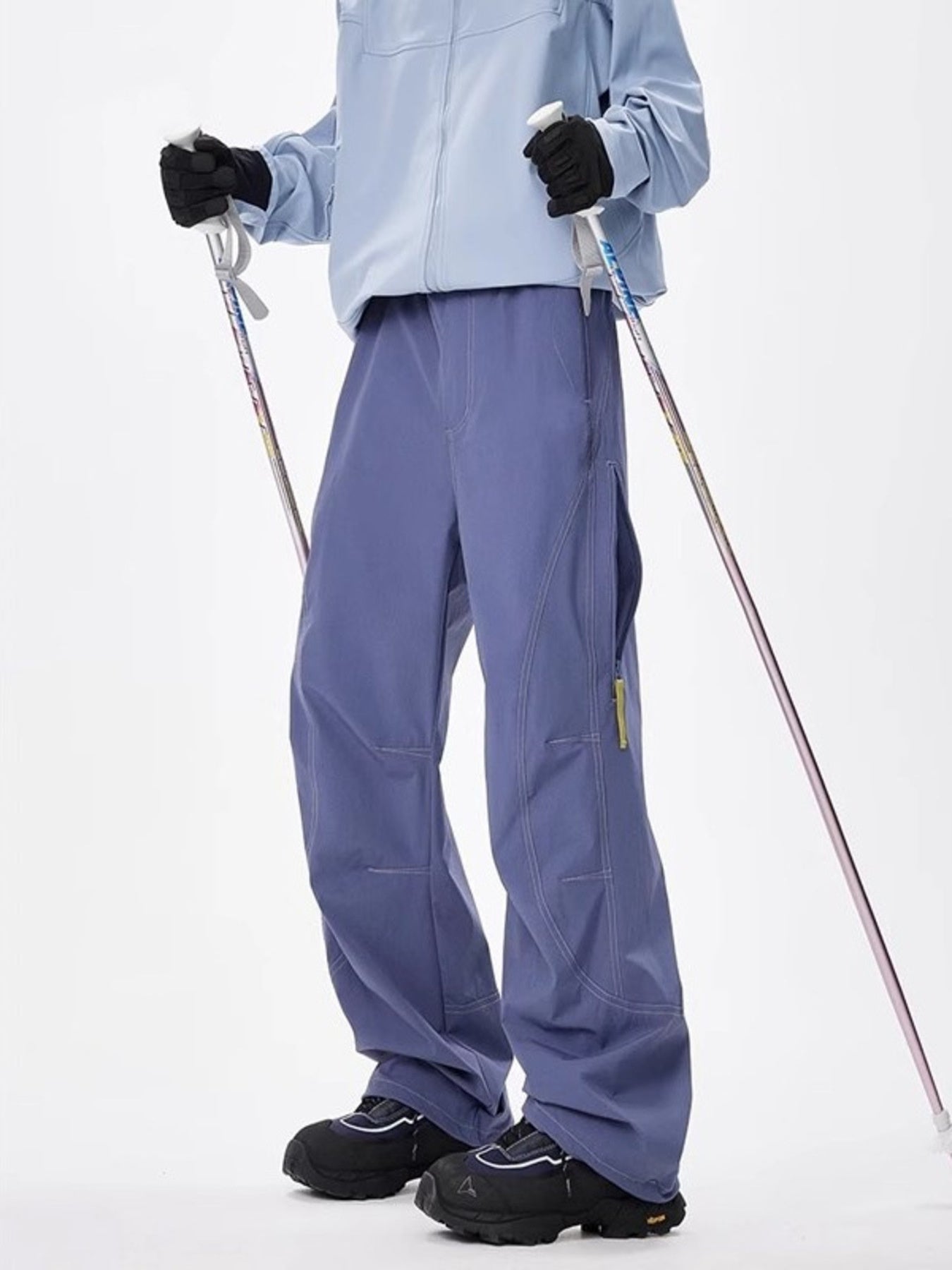 Men's blue loose fit cargo sweatpants with zippered pockets and contrast stitching.