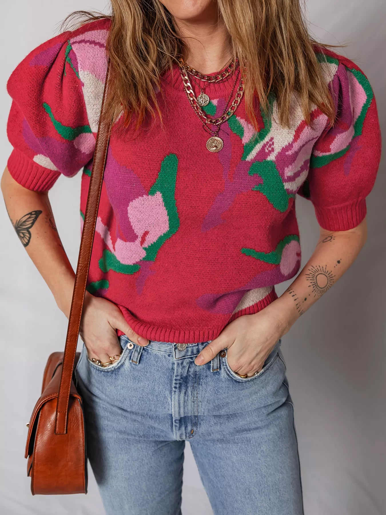Scarlet abstract floral puff sleeve sweater with crew neck and ribbed cuffs.