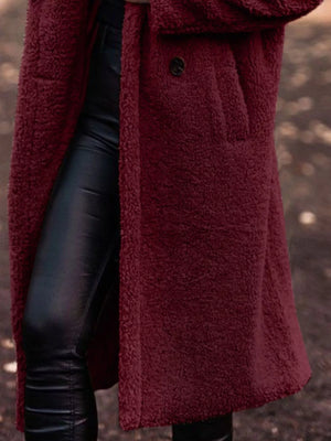 Wine Red teddy bear longline coat with button closure and pocket detail.