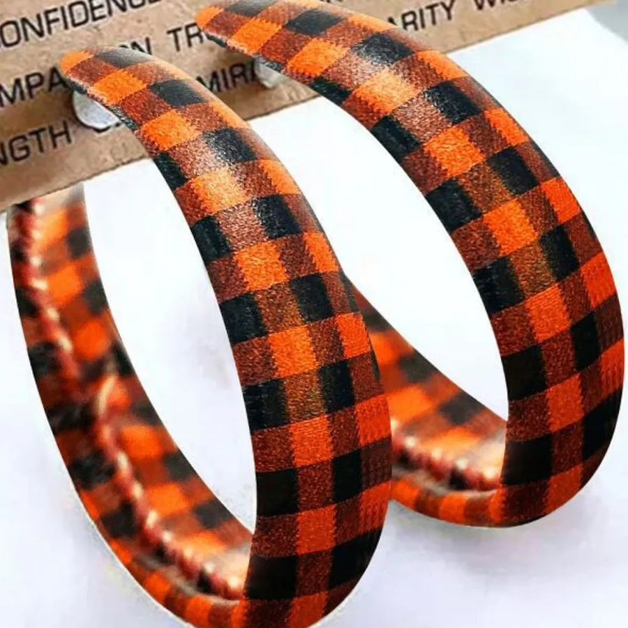 Orange and black buffalo check statement hoop earrings with alloy posts.