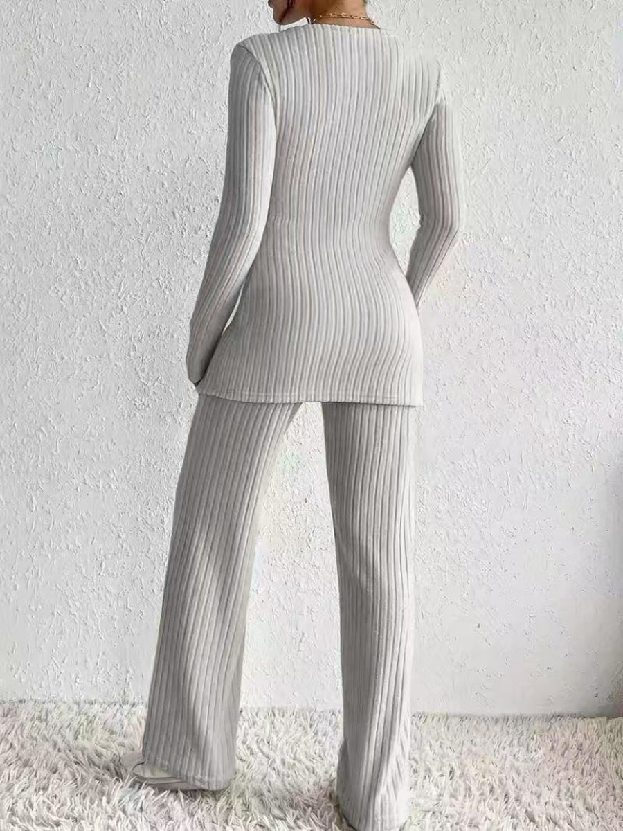 Ribbed knit lounge set in light gray, featuring a long sleeve top and wide leg pants.
