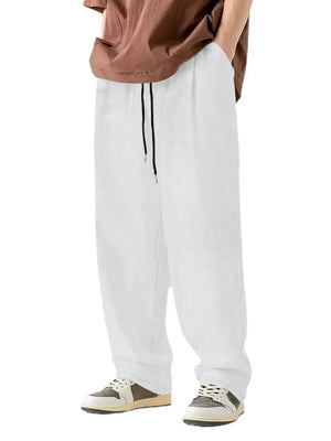 White corduroy relaxed fit trousers with drawstring and vertical texture.