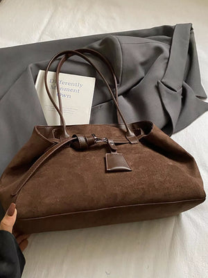 Brown suede shoulder bag with leather trim and tie closure detail