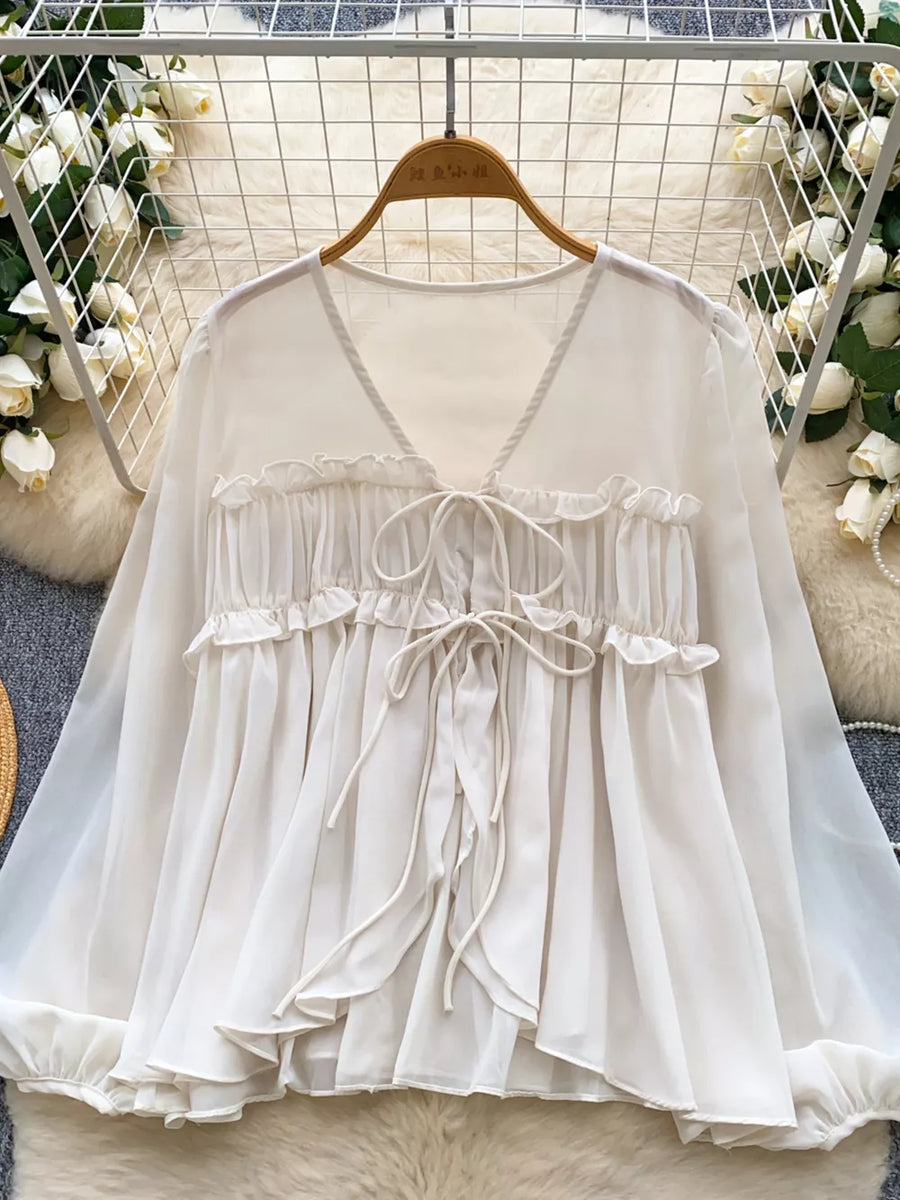 Chiffon tie-front blouse with ruffles and V-neck in Apricot.
