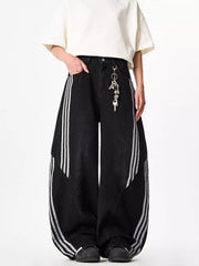 Black wide-leg jeans with white side stripes and a key chain detail.