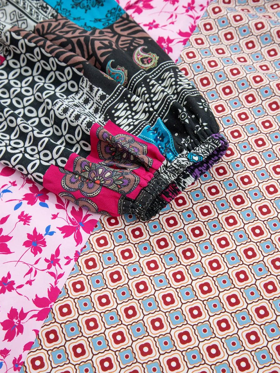 Boho floral print drop shoulder blouse with bubble sleeves in fuchsia pink and multi-color patchwork patterns.