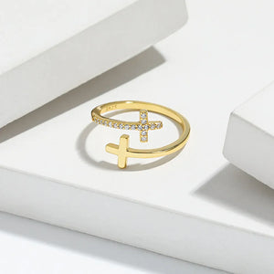 Gold open ring with two crosses, one with pave crystals, made of 925 sterling silver.