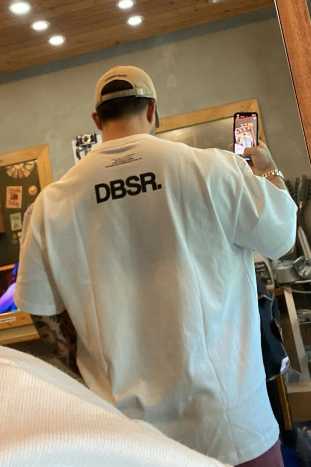White oversized tee with bold black DBSR back print and crew neck.