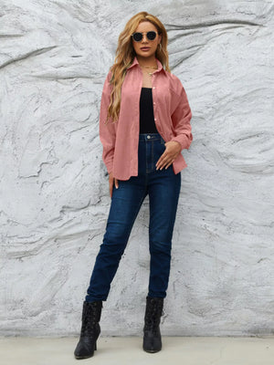 Classic corduroy button-up overshirt in Pinkish, styled open over a black top and jeans.