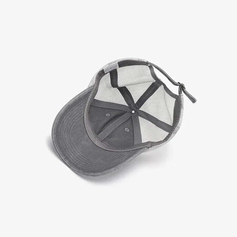 Gray vintage wash trucker hat with mesh back and adjustable strap.