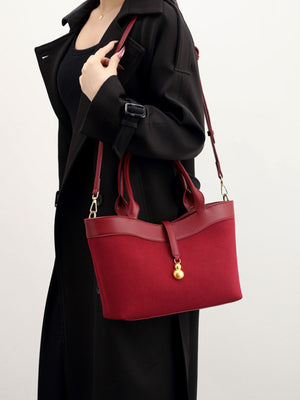 crossbody bag in burgundy featuring adjustable strap and structured fit