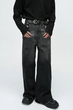 Faded panel wide-leg jeans in dark wash denim with a distressed hem.