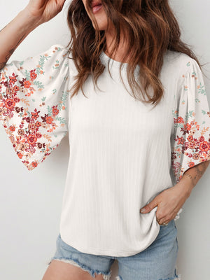 White ribbed top with floral print half sleeves and a crew neck.