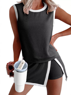 Black ribbed knit tank top and skort set with white trim and side slits.