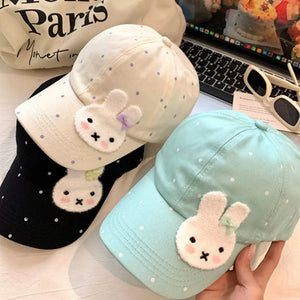 Bunny polka dot baseball cap in pastel blue, ivory, and black with applique bunny detail.