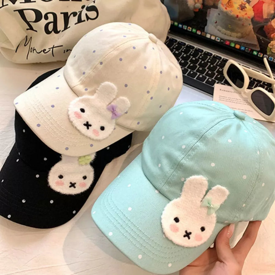 Bunny polka dot baseball cap in pastel blue, ivory, and black with applique bunny detail.