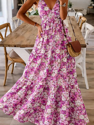 Floral maxi dress with spaghetti straps in a pink and white floral print, tiered skirt.