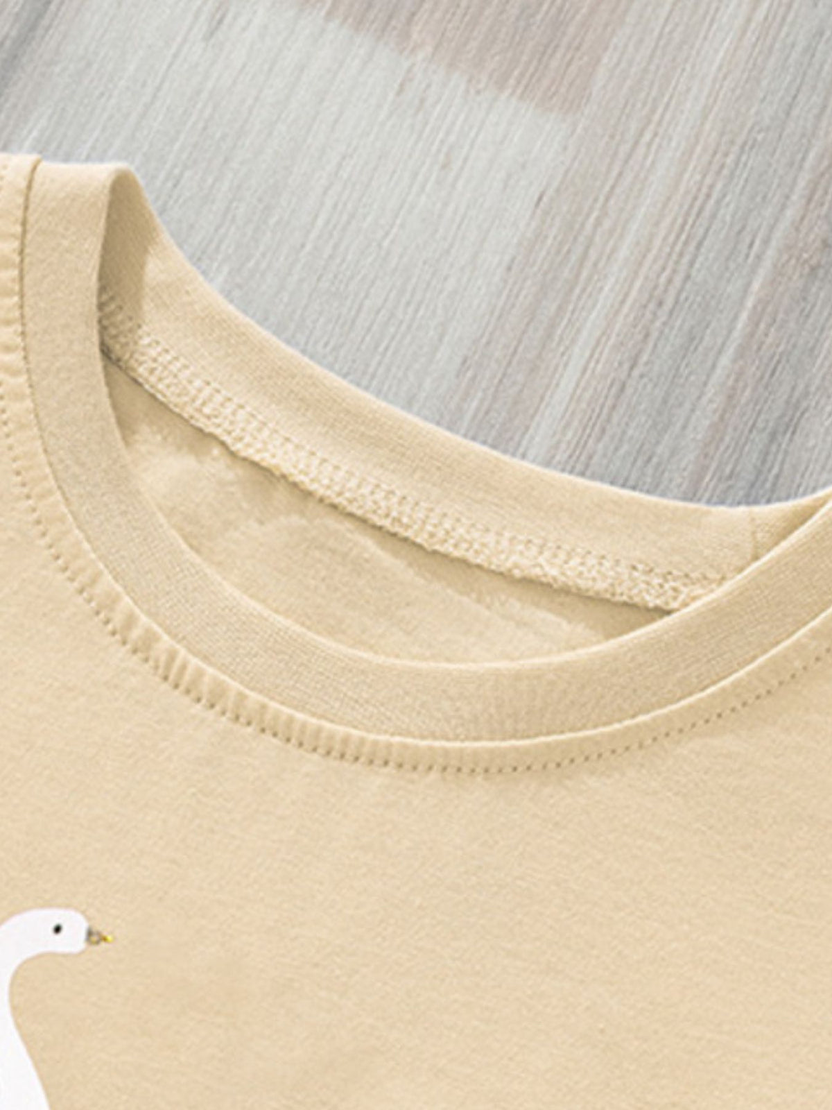 Beige cotton baby girls' t-shirt with swan print and ruffle sleeves