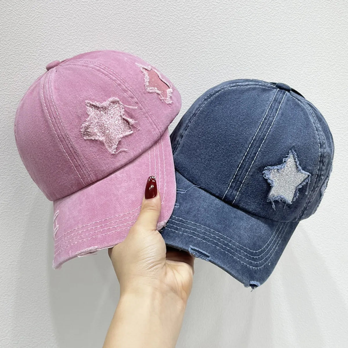 Stellar snapback cap baseball cap in dusty pink and dusty blue with distressed star patches.