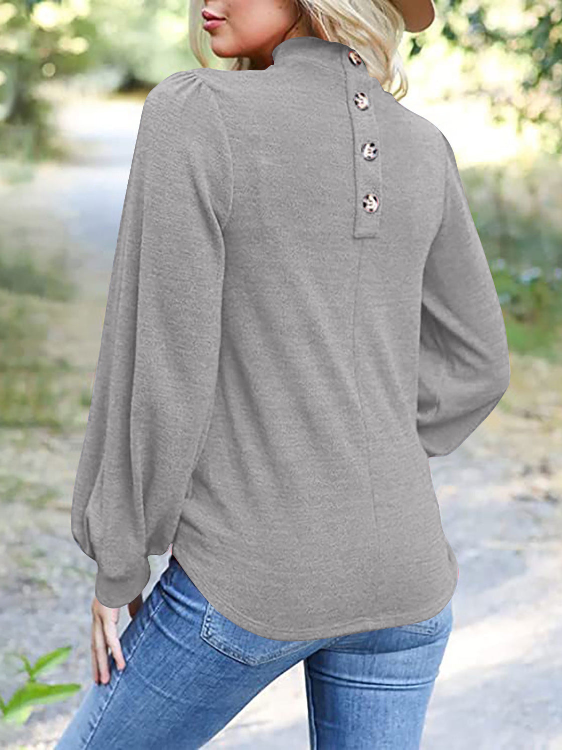 Gray mock neck top with puff sleeves and button-back detail