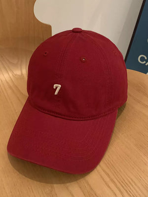Burgundy cotton baseball cap with embroidered white number 7 detail.