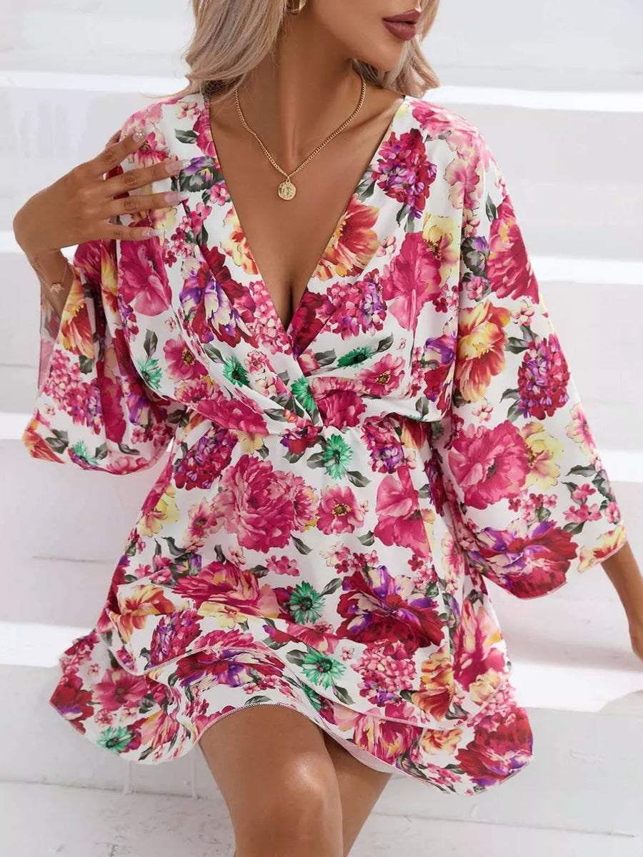 Floral ruffle hem mini dress with a deep V-neck and wide sleeves.