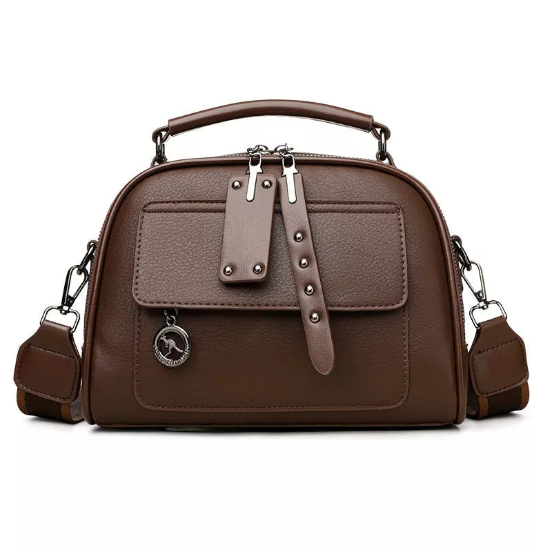 Brown structured crossbody bag with adjustable strap and silver kangaroo charm.